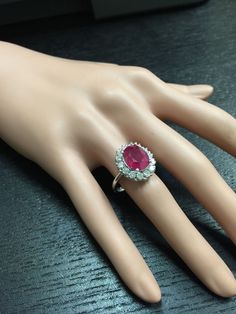 6.15 Carats Impressive Natural Red Ruby and Diamond 14K White Gold Ring Total Red Ruby Weight is: Approx. 5.15 Carats Ruby Measures: Approx. 11.00 x 9.00mm Natural Round Diamonds Weight: Approx. 1.00 Carat (color G-H / Clarity SI1-SI2) Ring total weight: Approx. 6.0 grams Disclaimer: all weights, measurements and colors are approximate and may vary slightly from the listed dimensions or as seen in the image. All pictures are magnified to show the smallest of details. Please, refer to the item de Red Cluster Diamond Ring With Brilliant Cut, Luxury Red Cluster Diamond Ring, Classic Red Cluster Diamond Ring, Platinum Ruby Ring With 17 Jewels, Luxury Red Gemstone Ring, Formal Ruby Ring, Luxury Red Cluster Ring, Red Cluster Ring With Brilliant Round Cut, Red Cluster Ring With Brilliant Cut