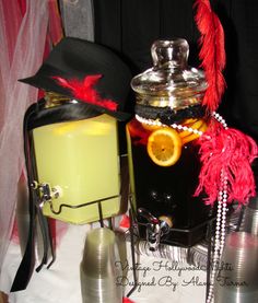 a table topped with an ice bucket filled with liquid and a hat on top of it