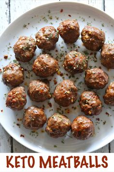 a white plate topped with meatballs covered in seasoning