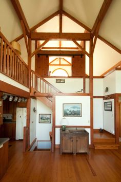 the inside of a house with wood floors and wooden railings on each side of the room