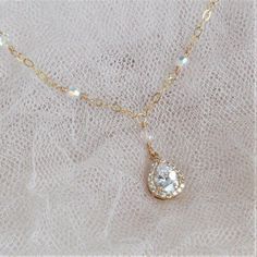 "* Gold Crystal Teardrop Necklace * * Gold cubic zirconia teardrop (1\" drop) necklace accented with Swarovski crystals and finished with a gold-filled clasp in 16\", 17\", 18\", 19\", or 20\" lengths. * Shown in a 16\" length. * Matching earrings coming soon ~ * TAKE 10% OFF $75 OR MORE WITH COUPON CODE ~ WEDDINGS10 * TAKE 15% OFF $100 OR MORE WITH COUPON CODE ~ WEDDINGS15 * This necklace will arrive in a box tied with a ribbon perfect for gift giving. Also, included will be a polish pad, anti- Gold Teardrop Bridal Necklace, Teardrop Crystal Bridal Necklace Gift, Wedding Bridal Necklace With Teardrop Crystal Pendant, Crystal Bridal Necklace With Teardrop Pendant For Party, Gold Teardrop Crystal Necklace For Wedding, Rose Gold Bridal Jewelry, Gold Bridal Necklace, Wedding Jewelry For Bride, Pearl Strands Necklace