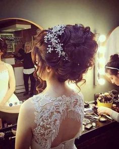 the bride is getting ready for her big day at the wedding ceremony in front of the mirror