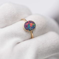 14K Yellow Gold Engagement Ring featuring an Oval Australian Doublet Opal. Free Domestic USPS First Class Shipping! Free One Year Limited Warranty! Free Gift Bag or Box with every order! Opal—the queen of gemstones, is one of the most beautiful and rarest gemstones on earth. Every piece of opals has its colors and patterns, which is perfect for designers to create unique engagement rings for someone extra special. We use 100% Natural & Ethically opal stones (NO synthetics or imitations) for our jewelry. ---------------------------------------------------------------ABOUT THIS PRODUCT14K Yellow Gold, Australian Doublet Opal, 1.15 ctMetal Color: GoldenOpal Color: Red, Yellow, Green & BlueRing Surface Measures: 11x9 MMRing Size: 7Occasion: Engagement/Birthday/Anniversary---------------------- Oval Opal Birthstone Ring, Gold Opal Ring With Oval Cabochon, 14k Gold Oval Birthstone Ring As Gift, Oval Opal Ring In Fine Jewelry Style, Yellow Gold Opal Ring With Round Stone As Gift, Round Opal Gemstone Ring As Gift, Yellow Gold Birthstone Ring With Cabochon For Gift, Fine Jewelry Birthstone Ring With Oval Cabochon, Oval Opal Birthstone Ring For Formal Occasions