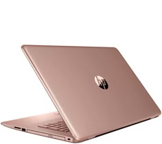 an open laptop computer sitting on top of a white surface with a gold finish to it