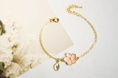 Super dainty Personalized Cherry blossom bracelet. ▶▶ You can make this necklace personal choosing the quantity of letter leaf from option. Please leave a note for the desired letters in 'add your personalization' ▶ Material - Gold plated over brass, Pearl ▶ Chain Length - 5 ~ 9 inches (Please choose it from option) ▶ charm measure - Flower H. 14mm x W. 13mm, Initial leaf ▶ The matching necklace available https://www.etsy.com/listing/196300602/cherry-blossom-necklace-sakura-necklace The matching Pink Flower Charm Jewelry For Bridesmaid Gift, Flower-shaped Bracelets For Bridesmaids, Flower Charm Bracelet As A Gift, Dainty Flower Shaped Personalized Bracelets, Cute Rose Gold Flower Jewelry, Rose Gold Flower Charm Bracelet As Gift, Elegant Charm Bracelet With Flower Charm As Gift, Gold Flower Charm Bracelet For Weddings, Elegant Flower Charm Bracelet Gift