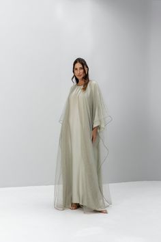 The Luxor Set is the epitome of understated opulence, with a silk inner dress that promises a sumptuous feel against the skin, offering both breathability and a subtle sheen. Draped over this is a beaded organza kimono, a masterpiece of craftsmanship that balances intricacy with airiness. The organza, known for its fine, lightweight texture, adds a layer of sophistication with its beadwork, catching the light and providing a delicate sparkle. This combination of silk and beaded organza makes the Luxor Set a luxurious choice for those who appreciate the fine art of dressing. The set comes with the beaded Kimono, Silk inner Dress, Chiffon Scarf. Organza Kimono, Silk Abaya, Scarf Making, Glamorous Evening Dresses, Glamorous Outfits, Modest Swimwear, Stylish Party, Dress Chiffon, Chiffon Scarf