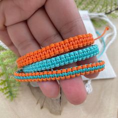 three crocheted bracelets being held by a hand