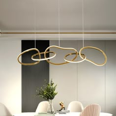 a dining room table with chairs and a chandelier hanging from the ceiling