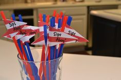 red, white and blue straws in a glass with writing on them that say sippy hour