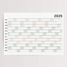 a wall calendar with the dates for each month in green and beige colors, on a white background