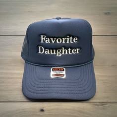 "Favorite Daughter" embroidered on your favorite color Otto Foam High-Profile Trucker Hat. How to Order: 1. Choose the color hat  2. Pick the color of thread   Message us with any questions. Hat Description:  The Traditional Look 5-panel cap Seamless Foam Front Panel with Lining Matching Color Braid Visor Matching Fabric Undervisor, Adjustable Snapback SHAPE: High-Profile FABRIC:  100% Polyester Front,  Mesh Back VISOR: Pre-curved FIT & SIZE: OSFM - Adult (6 1/2 - 7 5/8) Youth Size (6 - 7 1/8) S Gifts For Adult Daughter, Custom Trucker Hats, Prep Style, Embroidered Gifts, Favorite Daughter, Diy Hat, Hat Ideas, Embroidered Hats, Gifts For Adults