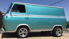 a blue van parked on the side of a road