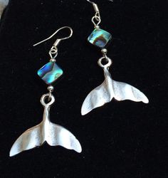 Abalone shell silver whales tail Boho beach earrings. These hand cast whales tail earrings have lots of detail and richness. They are Sterling silver over pewter hand cast with abalone shell beads. They look fabulous on everyone! Very light weight! Ear wires are sterling silver. These earrings are 2 inches long and 1 inch wide across the tail. All my jewelry comes gift boxed with a custom Shelly Mariposa Design butterfly card ready for gift giving, whether it is a gift for you or someone special Whales Tail, Shell Mermaid, Tail Mermaid, Abalone Jewelry, Beach Jewelry Boho, Save The Whales, Abalone Earrings, Design Butterfly, Earrings Beach