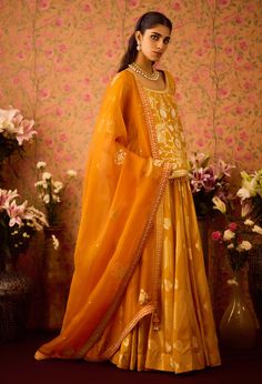 Step into refined elegance with the gold yellow appliqué silk brocade choli kurta, beautifully paired with a multi-panel brocade lehenga. This stunning ensemble showcases intricate appliqué detailing that enhances the luxurious brocade fabric, while the flowing lehenga offers a beautiful silhouette. Complemented by an embroidered dupatta, this outfit is perfect for festive occasions, blending traditional charm with modern sophistication. Gold Embroidered Raw Silk Palazzo Set, Semi-stitched Yellow Palazzo Set In Chanderi, Yellow Bollywood Palazzo Set With Cutdana, Navratri Traditional Drape Dola Silk Palazzo Set, Navratri Dola Silk Palazzo Set With Traditional Drape, Bollywood Style Yellow Palazzo Set With Cutdana, Bollywood Style Yellow Cutdana Palazzo Set, Semi-stitched Brocade Sharara With Gota Work, Bollywood Yellow Cutdana Palazzo Set