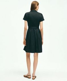 Introducing the ultimate wardrobe essential: the Belted Shirt Dress. Elevate your everyday style with its timeless design and versatile functionality. The pleated bodice and skirt add a touch of sophistication to the classic shirt dress silhouette, while the forward point collar and elongated neckline exude understated elegance. Plus, with the addition of side-seam pockets, this dress seamlessly combines fashion and function. Crafted from 100% cotton, this dress is not only effortlessly chic but Classic Button-up Shirt Dress For Formal Occasions, Fitted Pleated Dress For Semi-formal Occasions, Classic A-line Pleated Dress For Office, Classic Midi Dress With Placket For Daywear, Daywear Dress With Spread Collar, Fitted Shirt Dress With Placket For Business Casual, Classic Short Sleeve Midi Dress, Elegant Fitted Dress With Collared Neckline, Collared Neckline Shirt Dress For Work