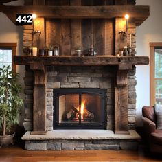 a fire place in a living room next to a couch and table with candles on it