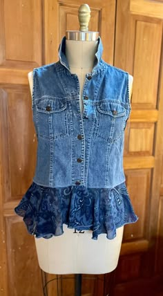 a mannequin wearing a denim vest with ruffles on the front and back