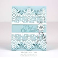 a blue and white christmas card with snowflakes