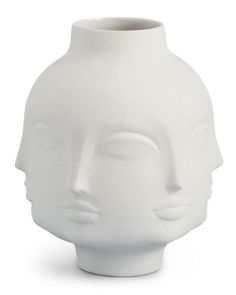 a white vase with a face on it