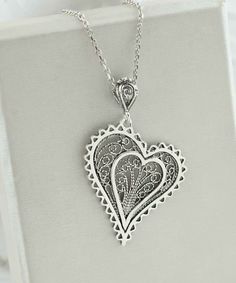 Introducing our Handcrafted Filigree Art Asymmetric Heart Figured Women's Silver Pendant Necklace! This stunning piece features a unique design with an asymmetric heart-shaped pendant, measuring 1.65 inches in height and 1.05 inches in width, suspended from a 20-inch silver chain. Expertly crafted with filigree art, this necklace is a beautiful addition to any jewelry collection. It comes with a silver polish cloth and a luxurious gift box, making it the perfect gift option for Mother's Day, ann Heart-shaped Metal Jewelry For Gifts, Bohemian Heart Pendant Necklace Gift, Heart-shaped Bohemian Wedding Jewelry, Bohemian Heart-shaped Wedding Jewelry, Metal Heart Pendant Necklaces For Wedding, Metal Heart Pendant Necklace For Wedding, Elegant Nickel-free Necklace For Valentine's Day, Unique Heart Charm Pendant Jewelry, Bohemian Silver Heart Charm Necklaces