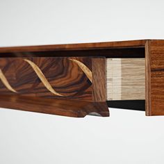 a close up of a wooden shelf with some wood on it's sides and the bottom section