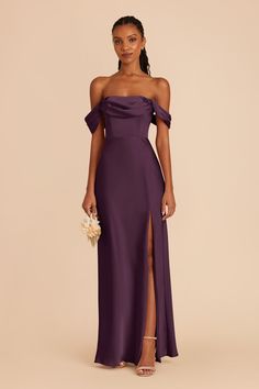 a woman wearing a purple dress with an off the shoulder slit