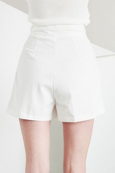 Grace Pintucked Shorts Front button and zip fly closure Front pintuck detail Short length Front functional pocket * Product Specification 100% Cotton * Flat Measurement: S/M: Waist: 31cm (12.2in) / Hip: 44cm (17.3in) / Thigh: 30cm (11.8in) / Rise: 32cm (12.6in) / Hem: 32.5cm (12.8in) / Length: 39.5cm (15.6in) / * Professional Clean Only / Do Not Tumble Dry Model's height is 5′ 6″ (173cm) Bust 32in Waist 24in Hip 36in and wearing S/M 사이즈 정보Size information (단위:cm)(Unit : inch) SXS/S 사이즈 정보 Size i White Bottoms With Built-in Shorts For Work, High-waisted Solid Color Shorts For Work, High-waisted Shorts For Work, Elegant Short Length Solid Color Bottoms, Chic High-waisted Shorts In Solid Color, Chic High-waisted Solid Color Shorts, Chic Solid Color Short Bottoms, Solid Workwear Shorts With Pockets, Elegant Cotton Knee-length Shorts