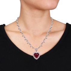 Gorgeously romantic is this trendsetting Red Cubic Zirconia Heart Necklace. Crafted in lustrous sterling silver, this beautiful necklace features 62 marquise-cut, 180 round-cut and two pear-cut shimmering white cubic zirconia gemstones along with one gleaming heart-cut red cubic zirconia gemstone (15 x 15 mm) dangling from the center. Enhanced with a high polish finish, this CZ necklace measures 18-inches long. Gift this distinctive gemstone necklace to your beloved to surprise her. Glamorous Heart Cut Jewelry For Valentine's Day, Valentine's Day Formal Cubic Zirconia Necklace, Glamorous Silver Necklace For Valentine's Day, Red Cubic Zirconia Heart Pendant Jewelry, Red Cubic Zirconia Heart Pendant Necklace, Fine Jewelry Lab-created Ruby Necklaces For Wedding, Fine Jewelry Wedding Necklace With Lab-created Ruby, Diamond Necklace For Valentine's Day Party, Lab-created Ruby Necklaces For Wedding