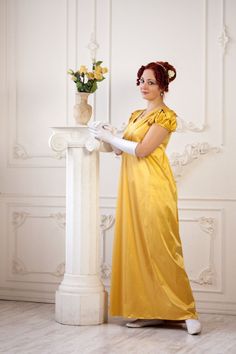 Yellow Regency dress is an outfit to attract as much attention as possible. It was done of pure but yet graceful shade of yellow satin atlas to make the gown shine at the ball, and make its mistress shine too. The bodice is made of gentle drapers and the sleeves' details add a playful note to the image. Costume copy of different materials and different colours is available, mainly the plain fabrics are in stock. Please, don't hesitate contacting me for asking more questions, making a copy or a n Elegant Yellow Ball Gown Dress, Elegant Yellow Dress For Debutante Ball, Elegant Yellow Gown For Debutante Ball, Elegant Yellow Ball Gown, Yellow Fitted Satin Gown, Yellow Satin Evening Dress For Wedding, Elegant Yellow Satin Gown, Yellow Satin Evening Dress, Elegant Yellow Floor-length Ball Gown