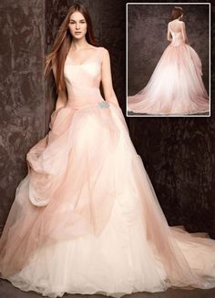 a woman in a pink wedding dress standing next to a wall