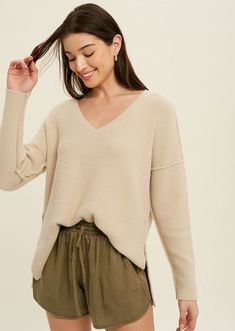 Cozy meets simple in the Susana Brushed Knit Top in oatmeal that features reverse seams.   Brushed sweater knit Side slits Reverse seams  High-low hemline  -Contents  100%Nylon    Model is wearing small size  -Approximate measurements are as follows  Small:Length:23 1/2" Bust:44 1/2"   Medium: Length 24" Bust:46 1/2"  Large: Length:24 1/2" Bust 48 1/2" Cozy Soft Knit V-neck Sweater For Layering, Chic Soft Knit V-neck Sweater, Oversized Neutral V-neck Sweater, Soft Knit V-neck Sweater For Loungewear, Cozy V-neck Knit Top For Fall, Cream Oversized V-neck Sweater, Oversized V-neck Sweater With Soft Texture, Cream Soft Knit V-neck Sweater, Soft Knit V-neck Top