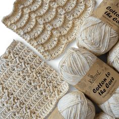 three balls of yarn are next to each other on a white surface with brown labels