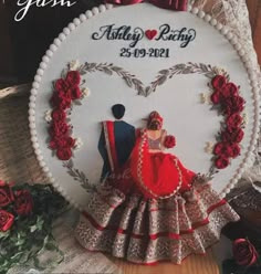 a wedding cake topper with a bride and groom in the heart surrounded by roses