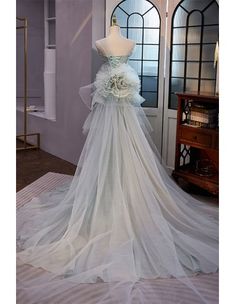 a wedding dress on display in front of a window