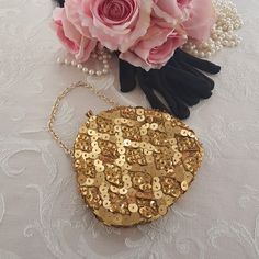 "Hand made vintage gold evening bag with golden beads & golden sequins. Gold-tone chain wrist strap. Small golden beads in a diamond pattern with smaller golden sequins in the diamond shapes and larger golden sequins between the diamonds. Tuck the gold-tone metal chain inside and convert to an evening clutch! Kiss lock at the top with two rhinestones. Gold tone metal bracket. Lined with yellow sateen and a handy pocket on one side. A small evening bag that hangs from the wrist or fingertips or c Gold Sequin Bags For Gifts, Gold Sequined Bags For Gifts, Gold Sequined Bags As Gifts, Gold Sequined Bags For Party, Gold Sequined Party Bag, Gold Sequin Party Bag, Gold Party Bags With Sequins, Gold Beaded Bag For Festive Occasions, Festive Gold Bag With Gold Beads