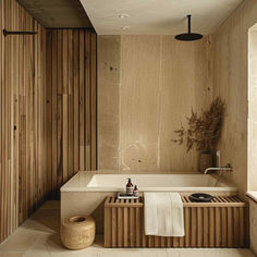 a bathroom with a bathtub, sink and towel on the counter next to it