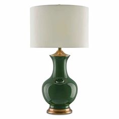 a green lamp with a white shade on it