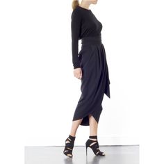 The Blake Tulip skirt is super flattering on any size. Coming in one size fits all, this wrap-around tulip style is designed to sit high on the waist. It's finished with a wrap-around belt that ties at the side, to nip in your waist for a flattering effect. Tie into a bow or leave as it is. This dramatic outline is best complemented with a fitted top. Hand wash recommended Wash with like colours to avoid colour transfer Press on reverse side Iron on low heat  100% polyester Elegant Draped Bottoms For Workwear, Relaxed Draped Evening Skirt, Evening Draped Lined Skirt, Elegant Draped Pleated Skirt, Asymmetrical Draped Skirt For Evening, Black Pleated Asymmetrical Evening Skirt, Asymmetrical Pleated Draped Skirt For Evening, Chic Draped Skirt For Night Out, Relaxed Draped Skirt For Evening