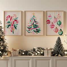 three christmas ornaments are hanging on the wall next to a tree and other holiday decorations