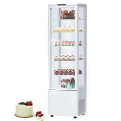 a white refrigerator freezer sitting next to a cake