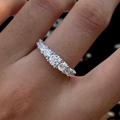 a woman's hand with a diamond ring on it