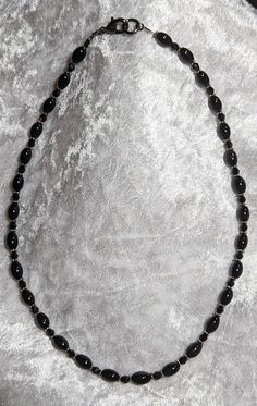 Black Crystal and Oval Onyx beads. Strung on very flexible wire. 18" long (end to end) Black Oval Beaded Necklaces, Black Necklace With Oval Spacer Beads, Onyx Bead, Black Crystals, End To End, Beaded Necklaces, Onyx, Beaded Necklace, Jewelry Necklaces