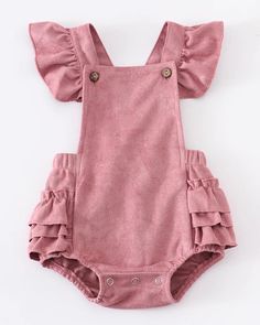 Suede is in this spring and this ruffled romper is stunningly precious.  Layer this beautiful style with a long-sleeved top or romper and tights.  This style coordinates with our Suede Ruffled Jonjon.  Snap button closure for easy changes.   Machine Washable.  Hang or Lay Flat to Dry.  Color: Rose  Sizes:  3M, 6M, 12M and 18M. Spring Cute Bubble Romper With Ruffle Sleeves, Spring Cotton Bubble Romper With Ruffle Sleeves, Spring Bubble Romper With Ruffles And Flutter Sleeves, Spring Ruffled Overall Jumpsuits And Rompers, Chic Long Sleeve Jumpsuits And Rompers With Ruffles, Cute Spring Bodysuit With Ruffles, Spring Ruffle Sleeve Jumpsuits And Rompers With Ruffles, Fitted Cotton Ruffle Bodysuit, Fitted Cotton Bodysuit With Ruffles