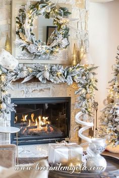 a living room decorated for christmas with white and gold decorations on the mantels