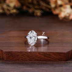 a diamond ring sitting on top of a wooden table