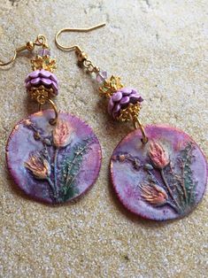 These Ceramic Earrings are made with charms made by an artisan.  The earrings are accented with ceramic and metal flower bead caps and Swarovski crystals Bohemian Hand Painted Dangle Flower Earrings, Handmade Artisan Purple Earrings, Handmade Pink Pendant Earrings, Purple Bohemian Hoop Earrings For Gift, Artisan Dangle Flower Earrings, Purple Artisan Earrings With Ear Wire, Artisan Flower Earrings For Pierced Ears As Gift, Artisan Purple Earrings With Ear Wire, Handmade Nature-inspired Pink Earrings