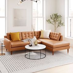 a living room filled with lots of furniture next to two large windows and a rug on the floor