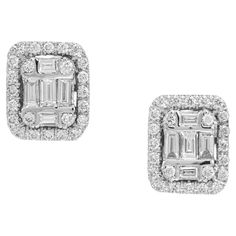 Stylish modern diamond rectangular earrings. Each earring has five baguette diamonds in the center and one round diamond in each corner. Both centers are haloed with round cut diamonds. These earrings have great brilliance along with a matching pendant necklace which you can view by entering this number in the search bar. 10 baguette diamonds, G-H VS SI approx. .34cts 48 round diamonds, H-I SI approx. .50cts 14k white gold Stamped: 14k 4.5 grams Top to bottom: 10.2mm or .40 Inches Width: 8.5mm or .33 Inches Depth or thickness: 4.4mm Please Note, we photograph each item as accurately as possible. However due to monitor/mobile device resolution and calibration, we understand some photos may vary in appearance. If you are not satisfied and offer a 30 day full money back return policy. Rectangular Earrings, Baguette Diamonds, Search Bar, Modern Earrings, Baguette Diamond, Mobile Device, Not Satisfied, Round Cut Diamond, Jewelry Earrings Studs