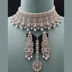 Introducing our Luxe Royal Heritage Collection, where timeless elegance meets modern sophistication. Elevate your ensemble with our Sania Choker Necklace Set, a captivating addition to this regal line. Meticulously designed in the USA and delicately detailed in India, this piece epitomizes opulence and grace. Lightweight and versatile, it effortlessly enhances any look with a touch of regal allure, making it an indispensable part of our Luxe Royal Heritage Collection. Handcrafted, Necklace Set i Luxury Formal Choker With Intricate Design, Opulent Hand Set Jewelry For Formal Occasions, Opulent Hand-set Jewelry For Formal Occasions, Luxury Intricate Design Choker Necklace, Opulent Diamond Jewelry For Formal Occasions, Opulent Formal Diamond Jewelry, Classic Wedding Necklaces With Diamond Accents, Luxury Hand Set Jewelry Sets For Wedding, Elegant Bridal Necklace With Intricate Design In White