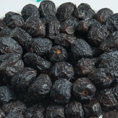 raisins in a white bowl on a table